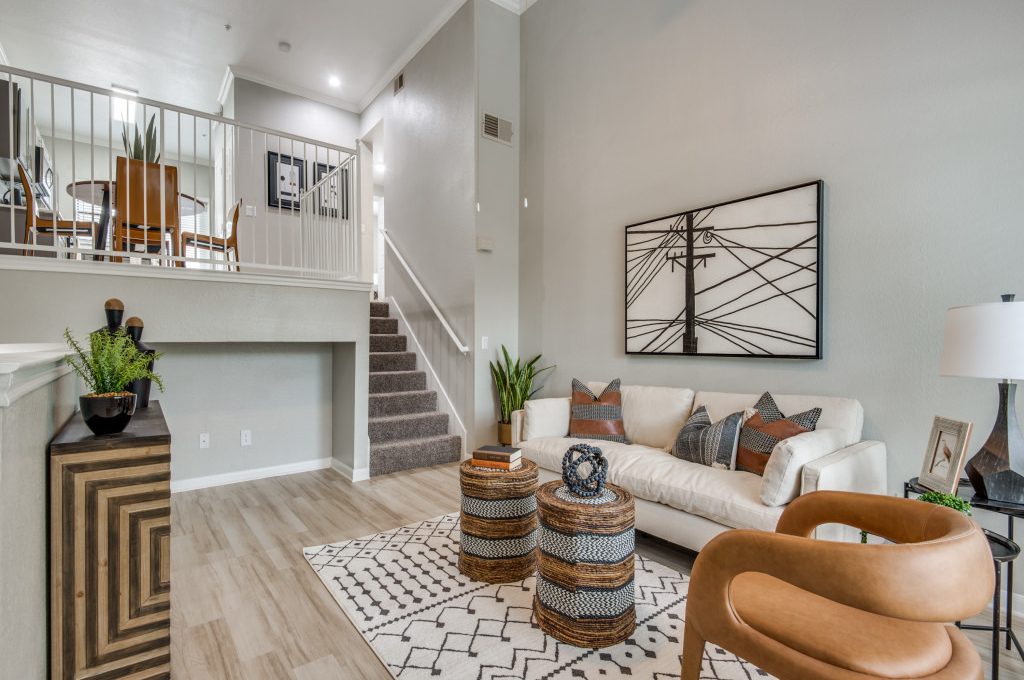 a living room with a staircase and a coffee table at The  Ellington