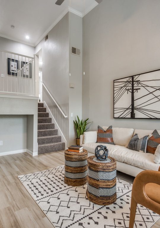 a living room with a staircase and a coffee table at The  Ellington